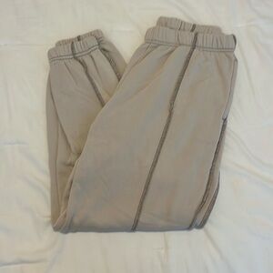 Cream sweatpants with stitched brown stripes